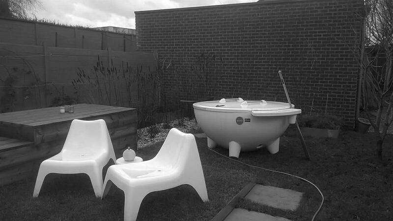 Zwart-witfoto van een Dutchtub op een terras met twee loungestoelen